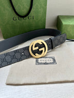 Gucci belt with dark gray GG monogram strap and gold-tone interlocking G buckle