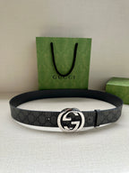 Gucci belt with dark gray GG monogram strap and silver-tone oval logo buckle