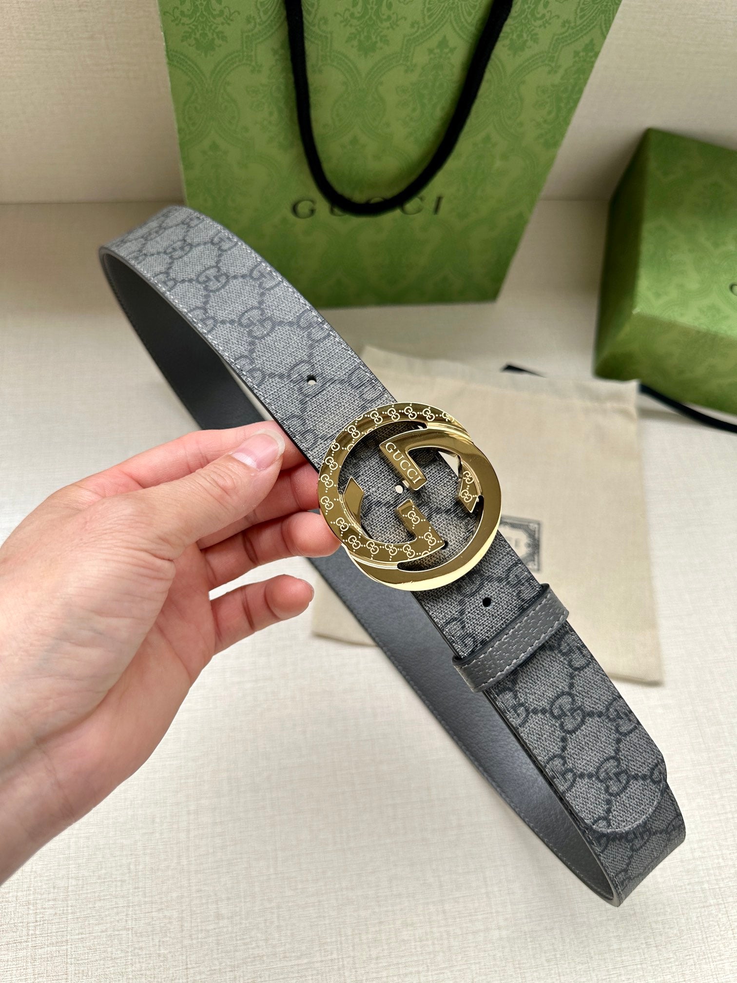 Gucci belt with dark gray GG canvas strap and gold-tone double G buckle