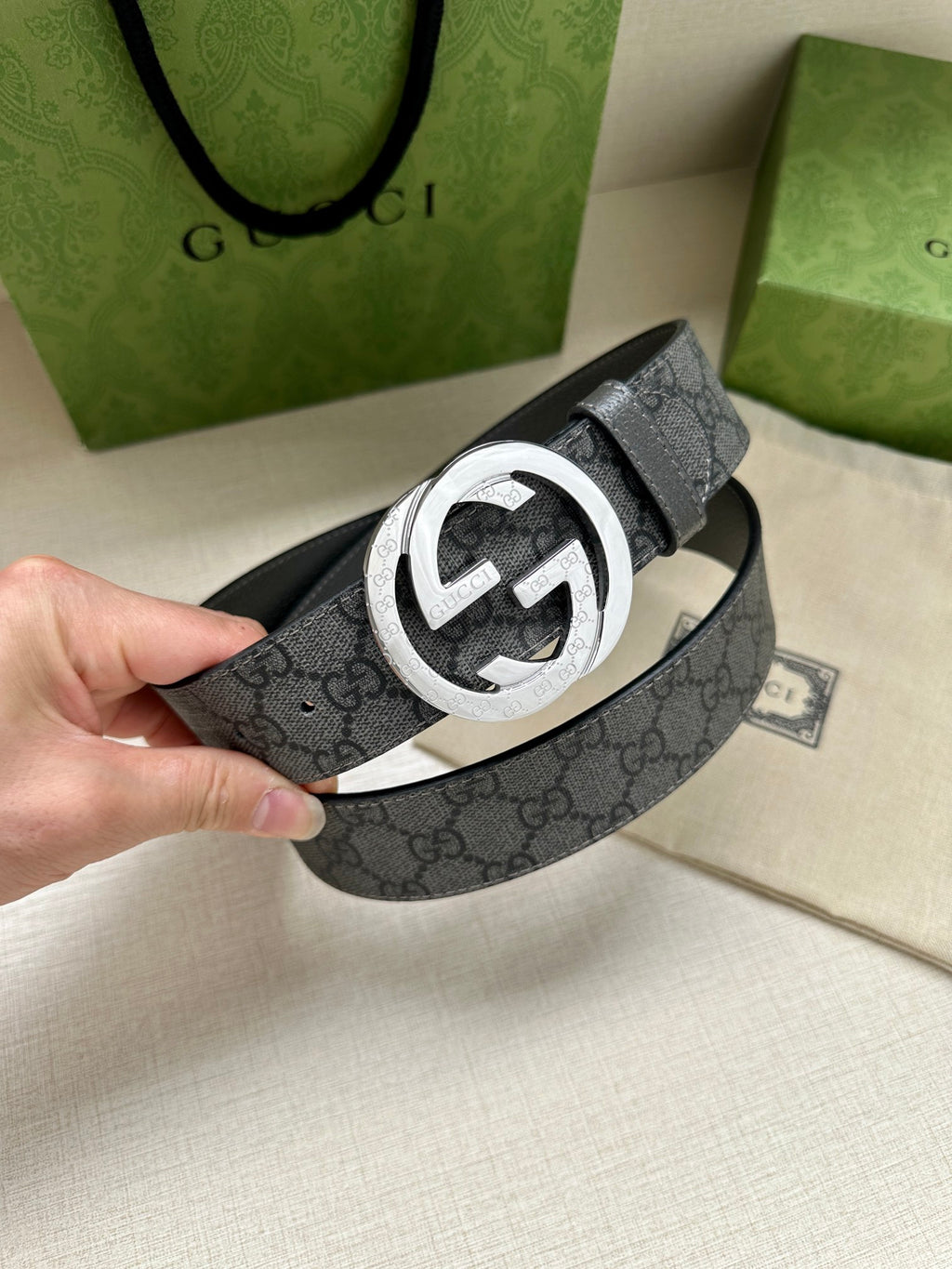 Gucci belt with dark gray GG monogram strap and silver-tone interlocking G buckle