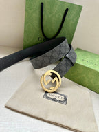 Gucci belt with dark gray GG monogram strap and gold-tone round logo buckle