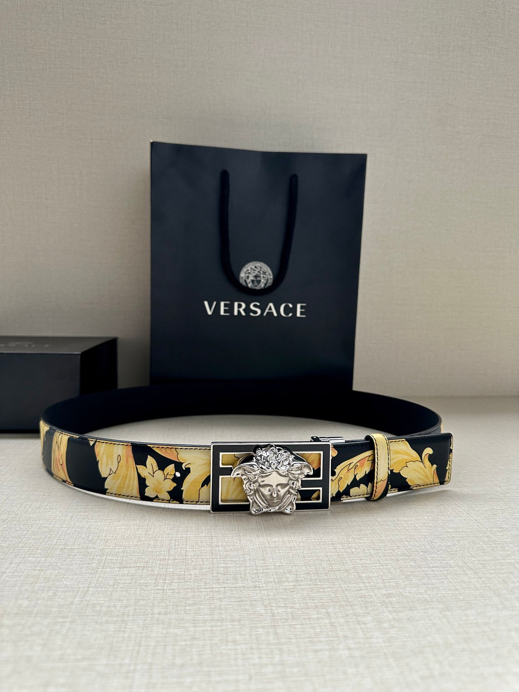 Versace leather belt with navy-and-gold floral band and silver-tone Medusa buckle.