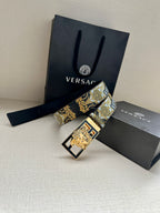 Versace belt with gold-blue patterned strap and gold square buckle, laid diagonally