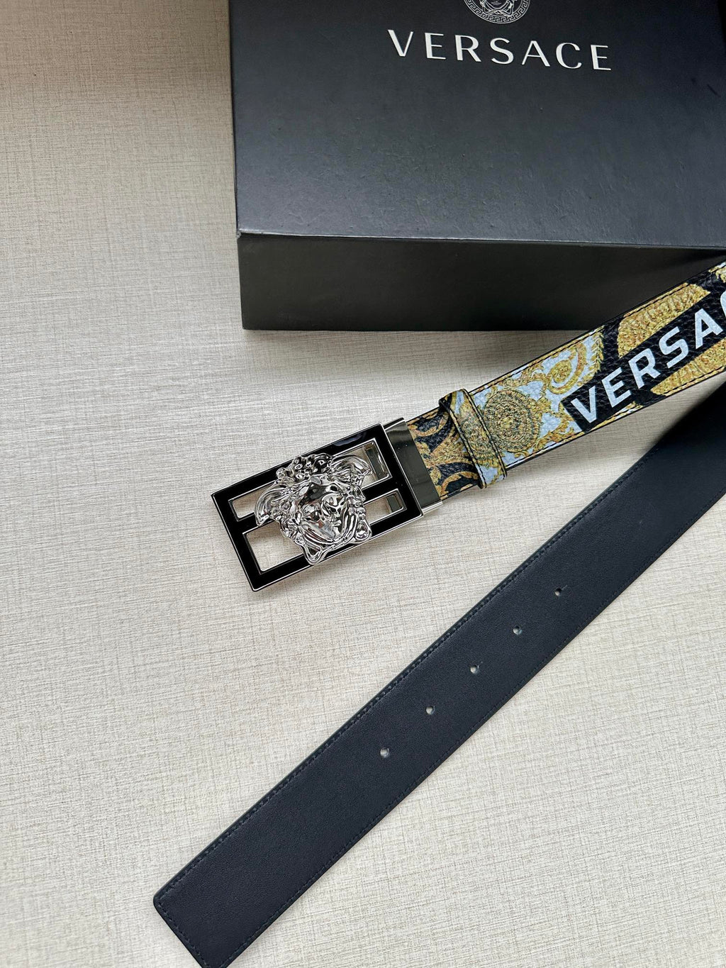 Versace belt with gold-blue patterned strap and silver-tone square buckle