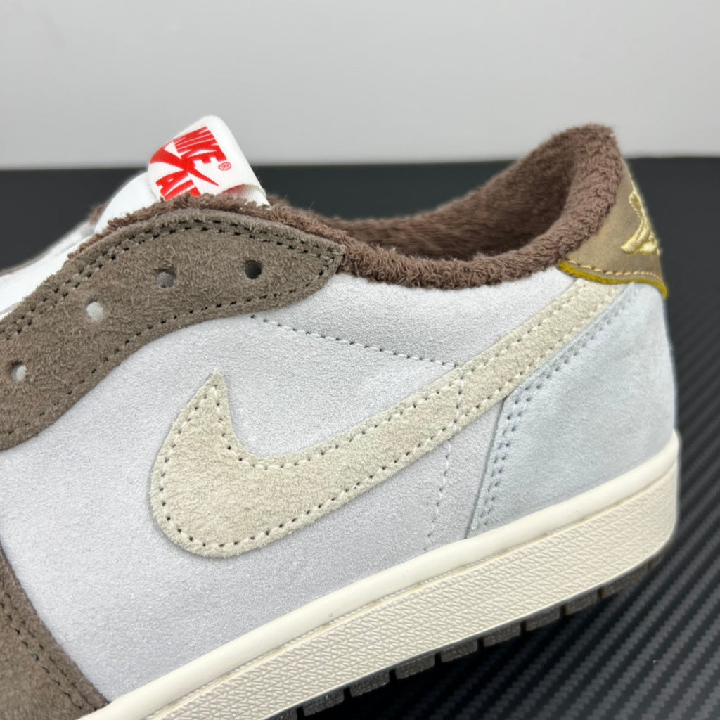 Low-top sneakers side view, light gray leather with brown suede and gold Swoosh detail