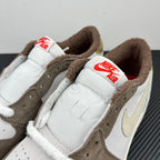 Low-top sneakers side close-up, white leather with brown lining and Nike Air tongue tag
