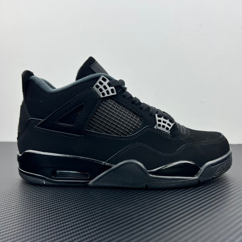 Mid-top Air Jordan 4 sneaker with dark upper, mesh side panel, and visible air unit