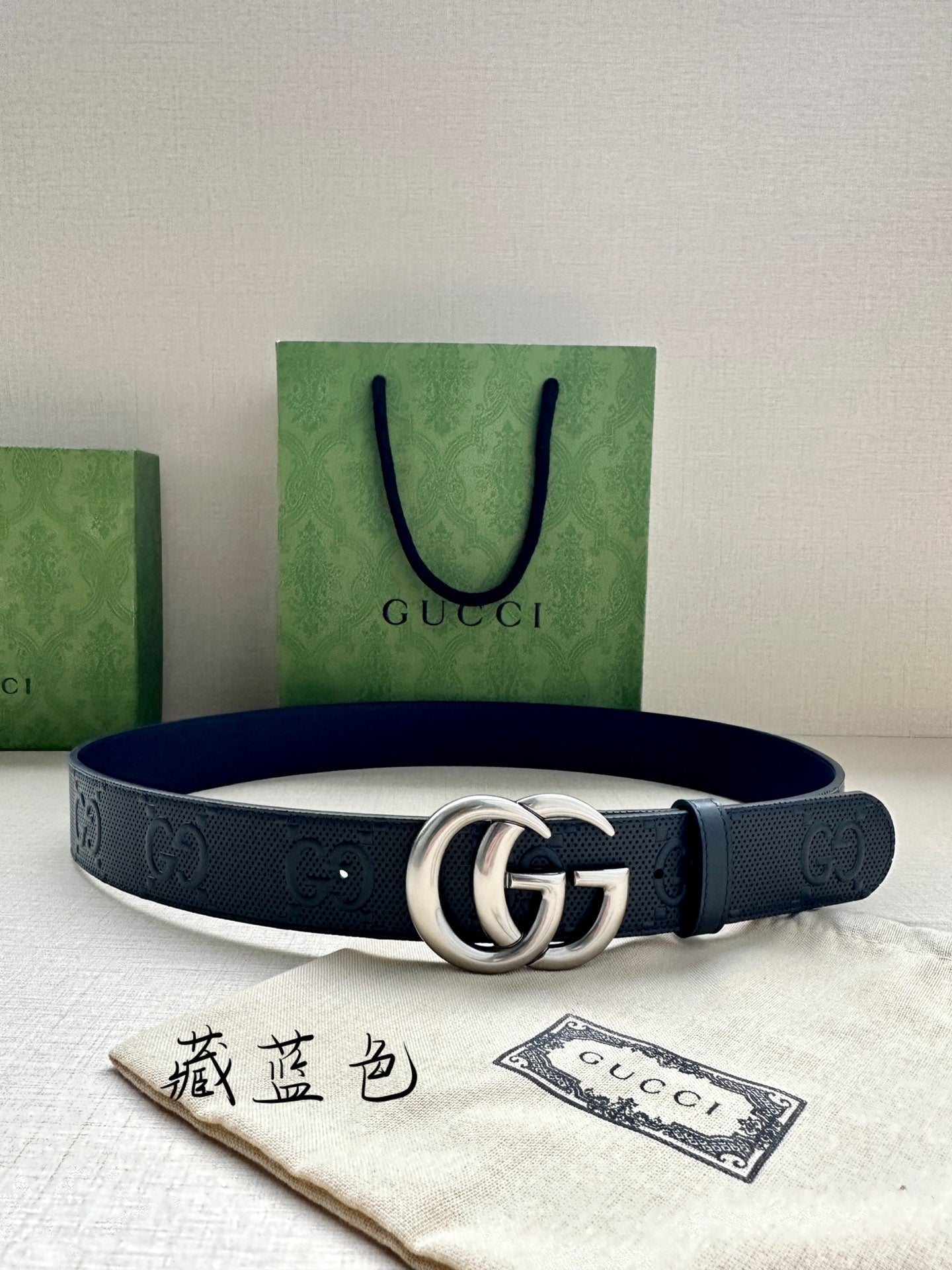 Gucci leather belt, dark navy, with silver double G buckle and embossed GG pattern