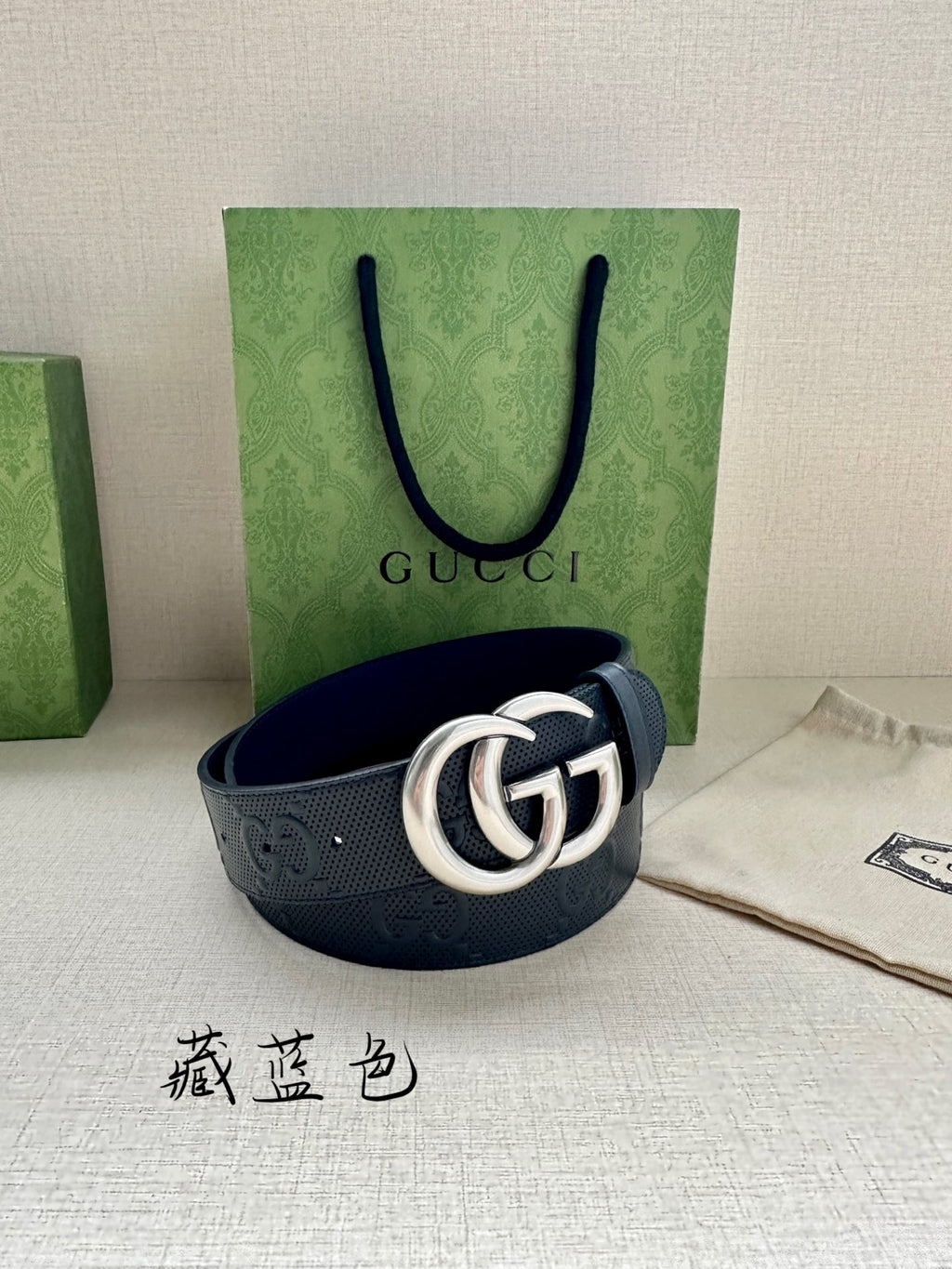 Gucci leather belt with silver double G buckle and dark navy embossed strap