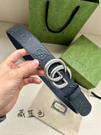 Gucci leather belt in dark navy with GG-style embossing and silver double G buckle
