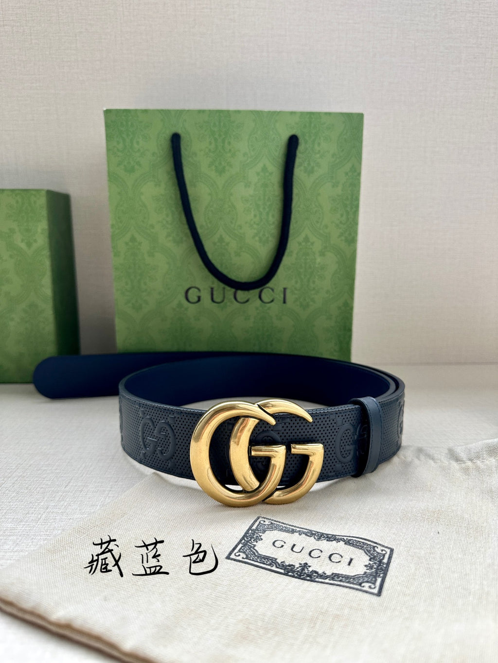 Gucci belt on fabric, dark blue GG-pattern strap with gold-tone double-G buckle