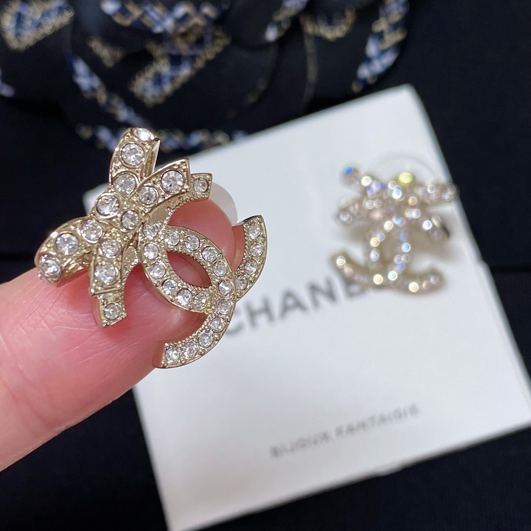 Rhinestone CC logo stud earring with gold-tone metal and pink enamel center
