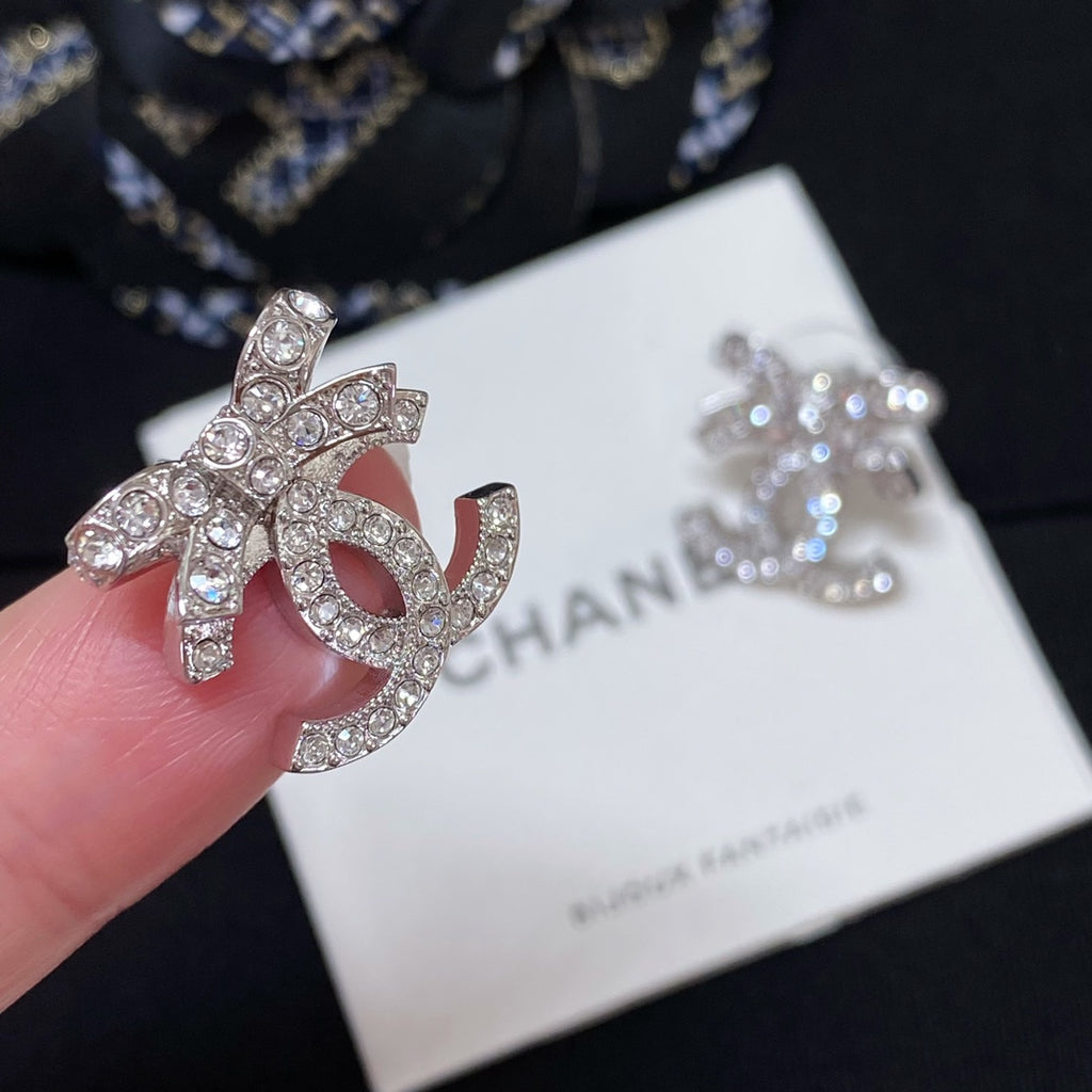 Rhinestone CC logo stud earring with silver-toned metal and pink enamel center