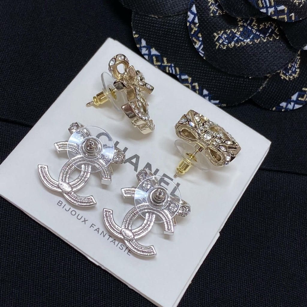 Gold and silver-tone rhinestone CC stud earrings with flower-like crystal surround