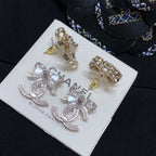 Gold and silver-tone rhinestone CC stud earrings with flower-like crystal surround