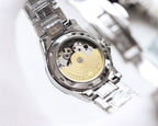Rolex wristwatch with exposed mechanical movement, gold-toned plate, stainless caseback.