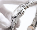 Rolex wristwatch side view with crown, stainless steel case and bracelet links.