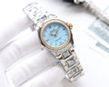 Rolex wristwatch with light blue dial, gold hands, stainless steel bracelet and bezel.