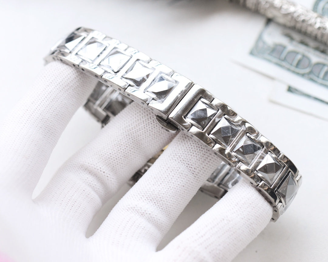 Rolex wristwatch bracelet in stainless steel with geometric link pattern.