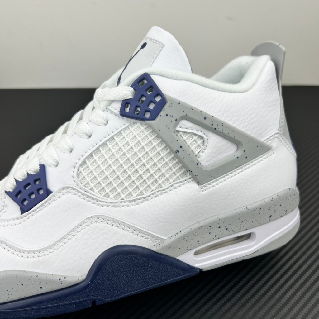Air Jordan 4 sneaker side view in white with navy sole trim and air unit