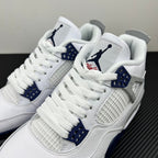 White Air Jordan 4 sneakers close-up with blue eyelets and woven side panel