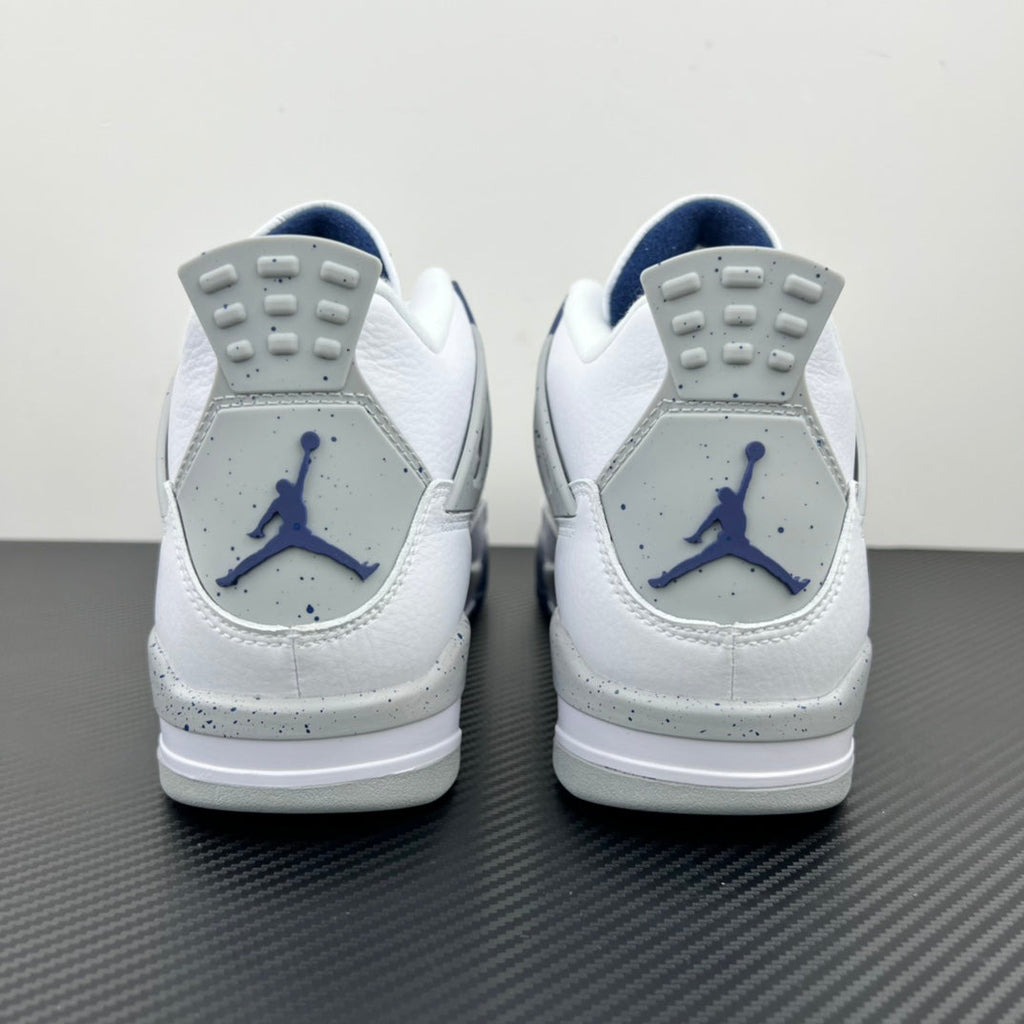 Air Jordan 4 sneakers from heel view in white with navy Jumpman logos