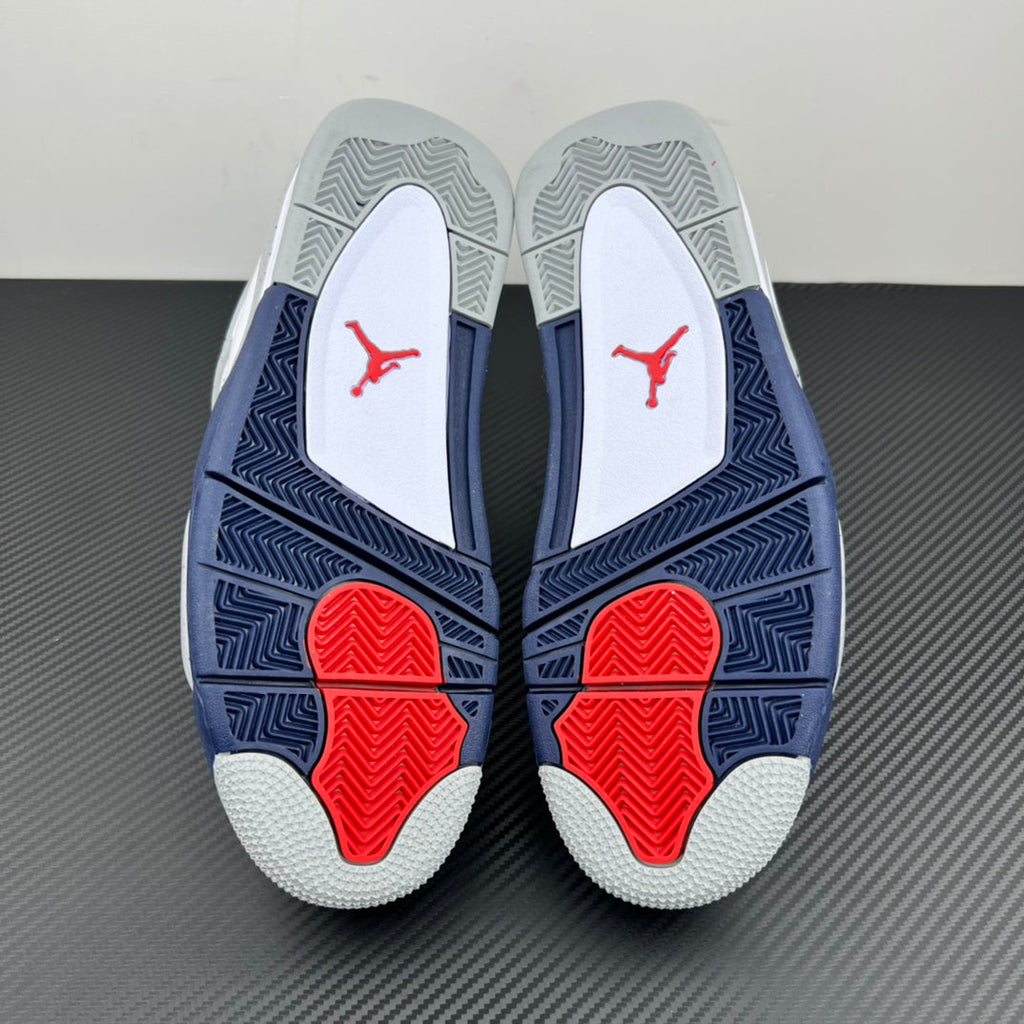 Air Jordan 4 outsole view with navy traction pattern and red heel pods