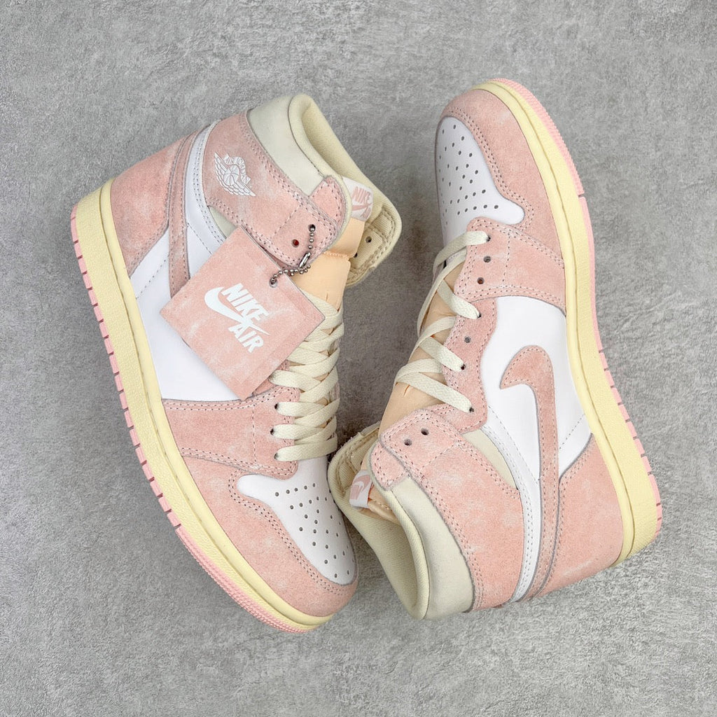 Two Air Jordan 1 Retro High OG sneakers shown at an angle with pink suede and white swooshes