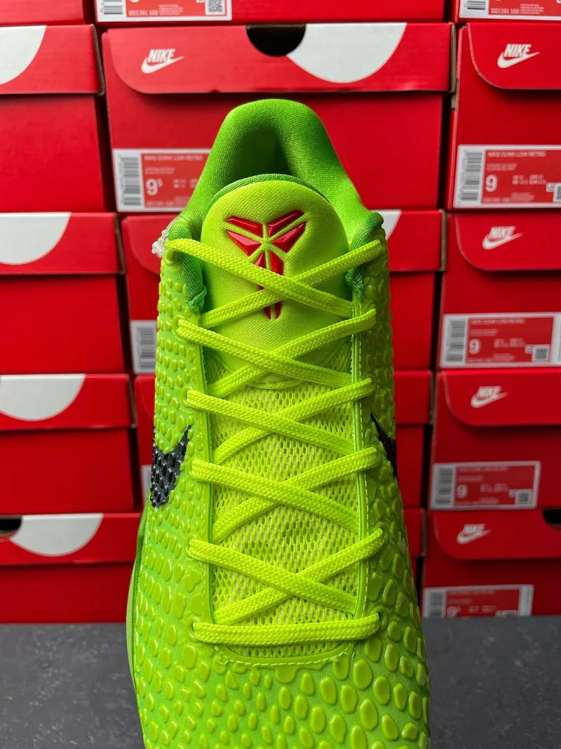 Bright green Nike basketball shoe with bright laces and red logo on tongue