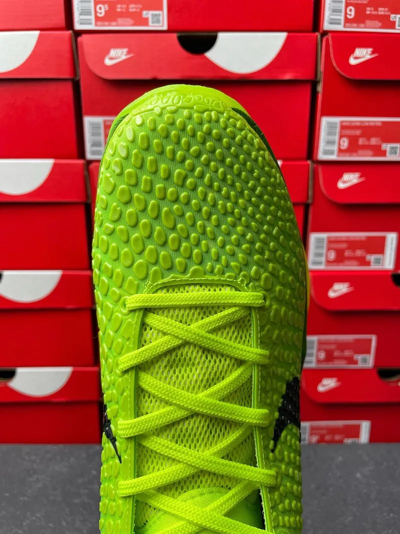 Bright green Nike sneaker toe view with lace panel and textured traction surface