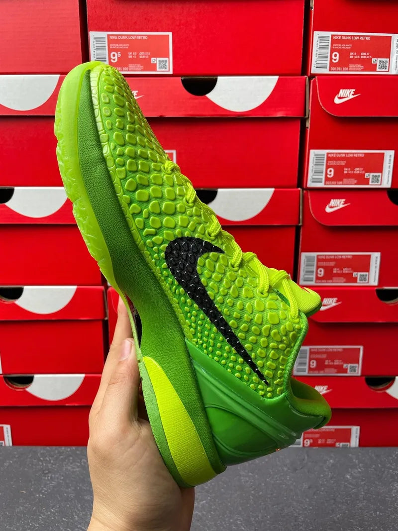 Bright green Nike basketball shoe bottom side view with black Swoosh