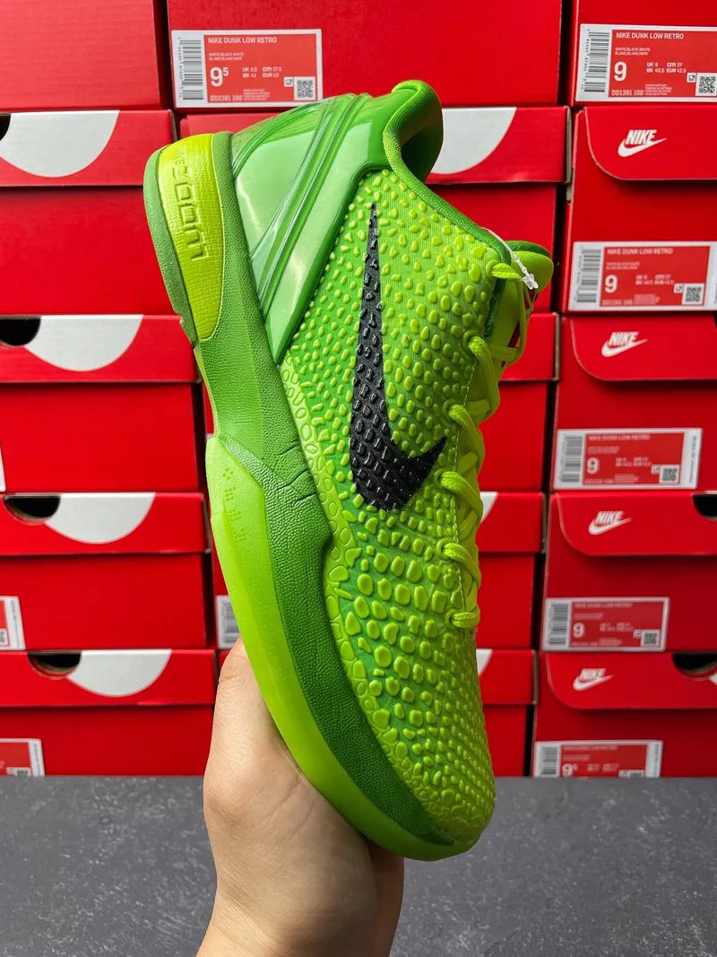 Bright green Nike basketball shoe with black Swoosh, textured upper, lace side