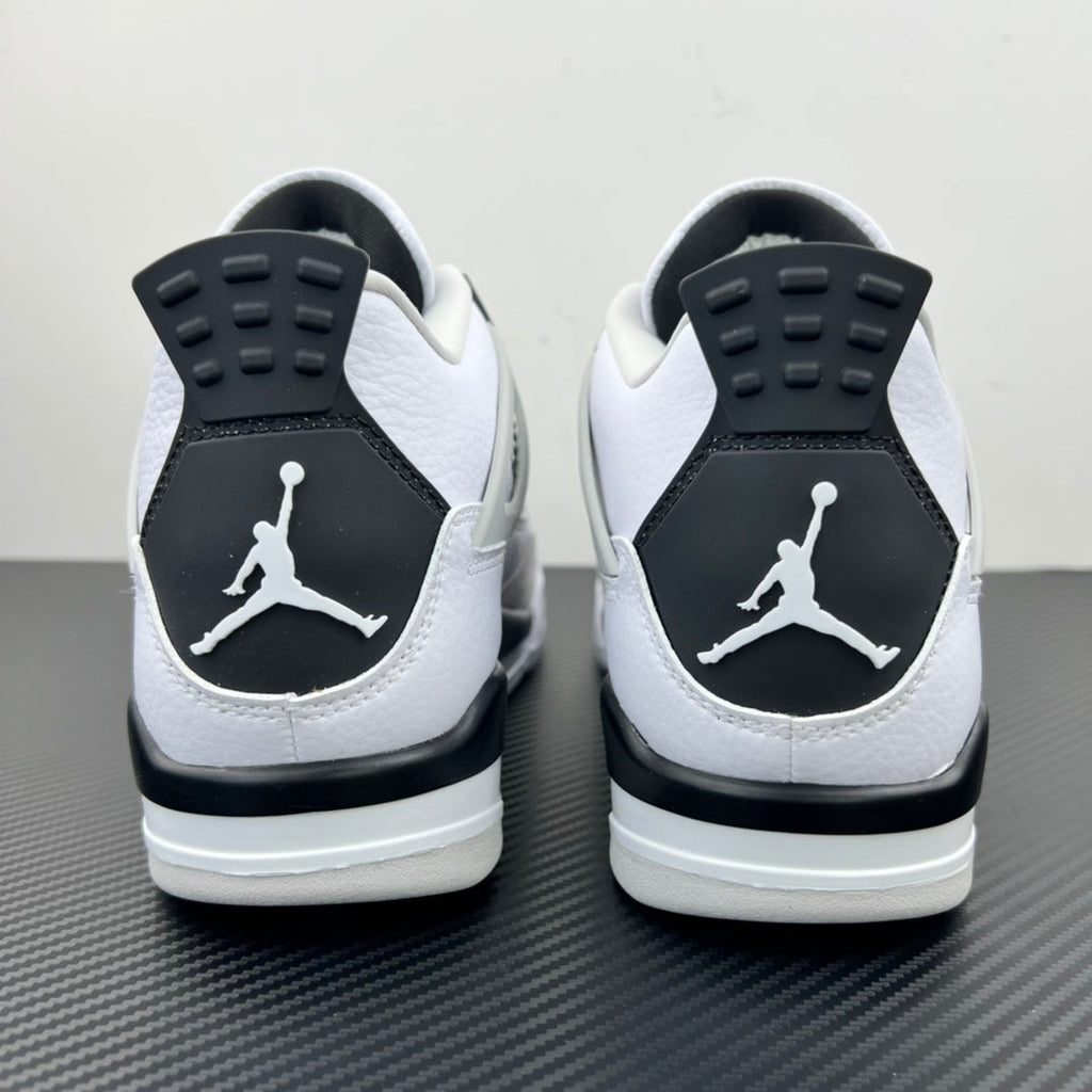 Air Jordan 4 sneakers with white uppers, black heel panels, and Jumpman logo
