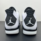 Air Jordan 4 sneakers with white uppers, black heel panels, and Jumpman logo