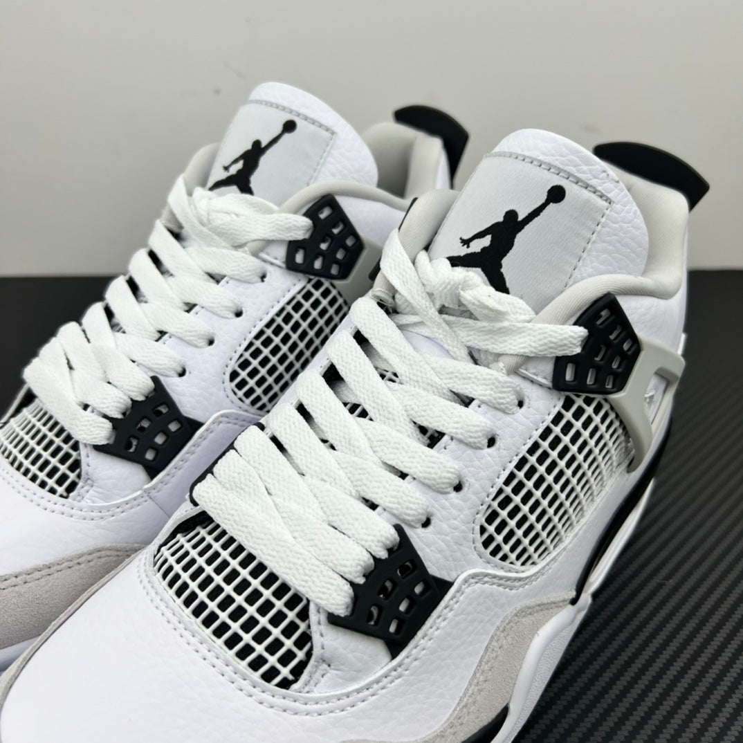 Pair of white Air Jordan 4 sneakers with black Jumpman logos and mesh side panels