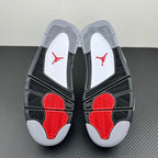 Pair of sneaker outsoles with black tread, red pods, and light grey traction
