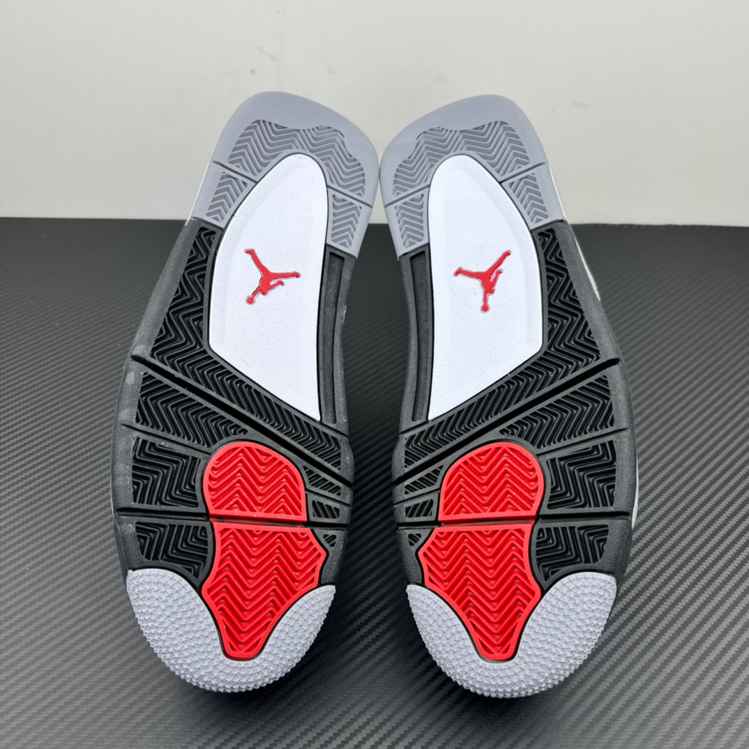Pair of sneaker outsoles with black tread, red pods, and light grey traction