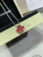 Silver clover pendant necklace with red enamel, on black gift box
