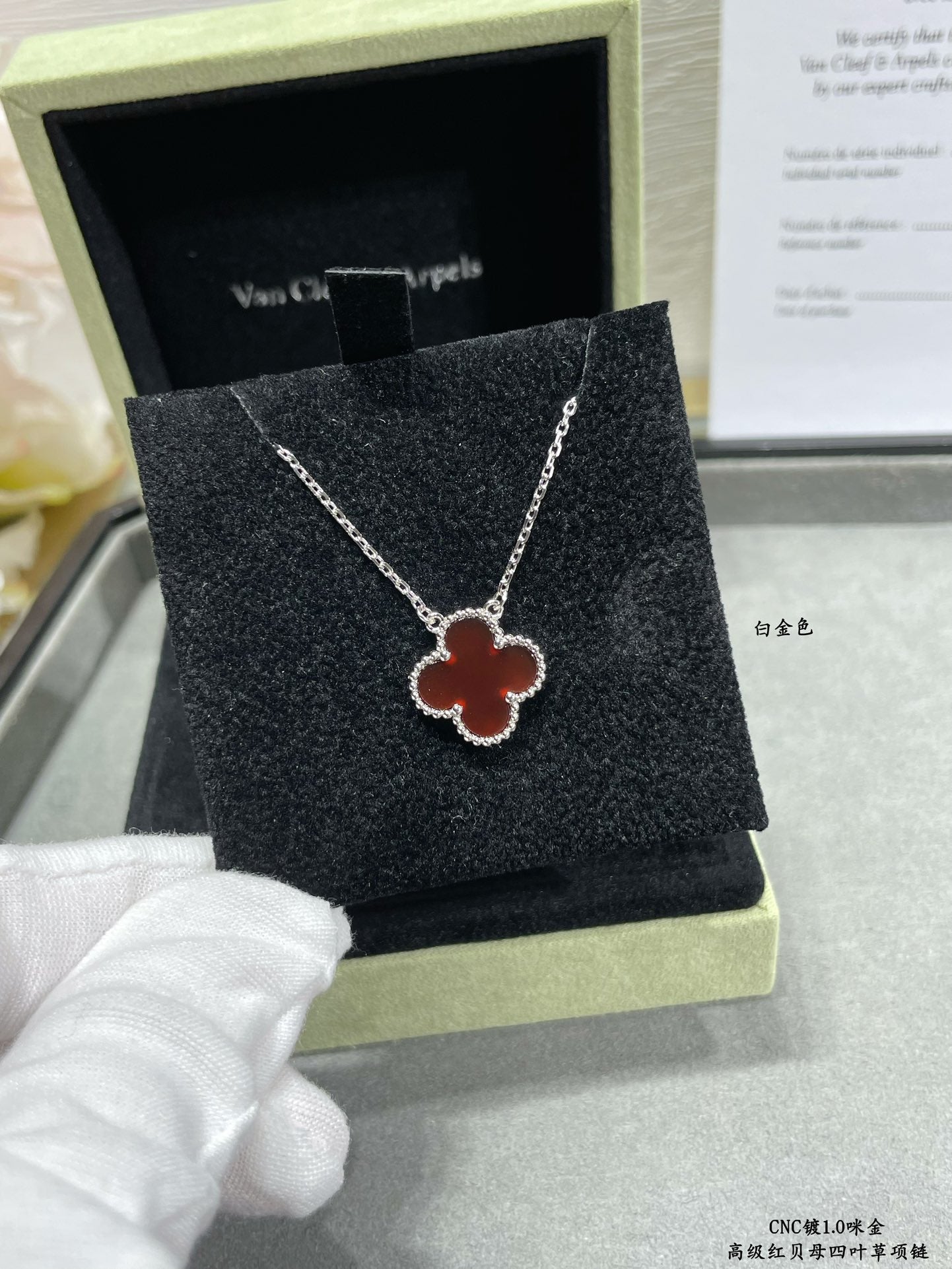 Silver clover pendant necklace on black jewelry box