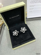 Silver flower stud earrings in black jewelry box