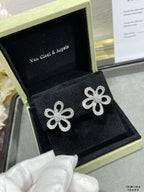 Silver flower stud earrings in black jewelry box
