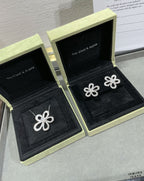 Silver flower stud earrings in open black boxes