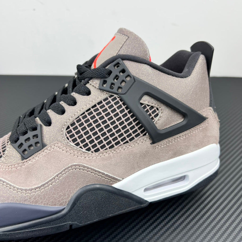 Taupe Air Jordan 4 sneaker close-up with black side panel, mesh window, and air unit