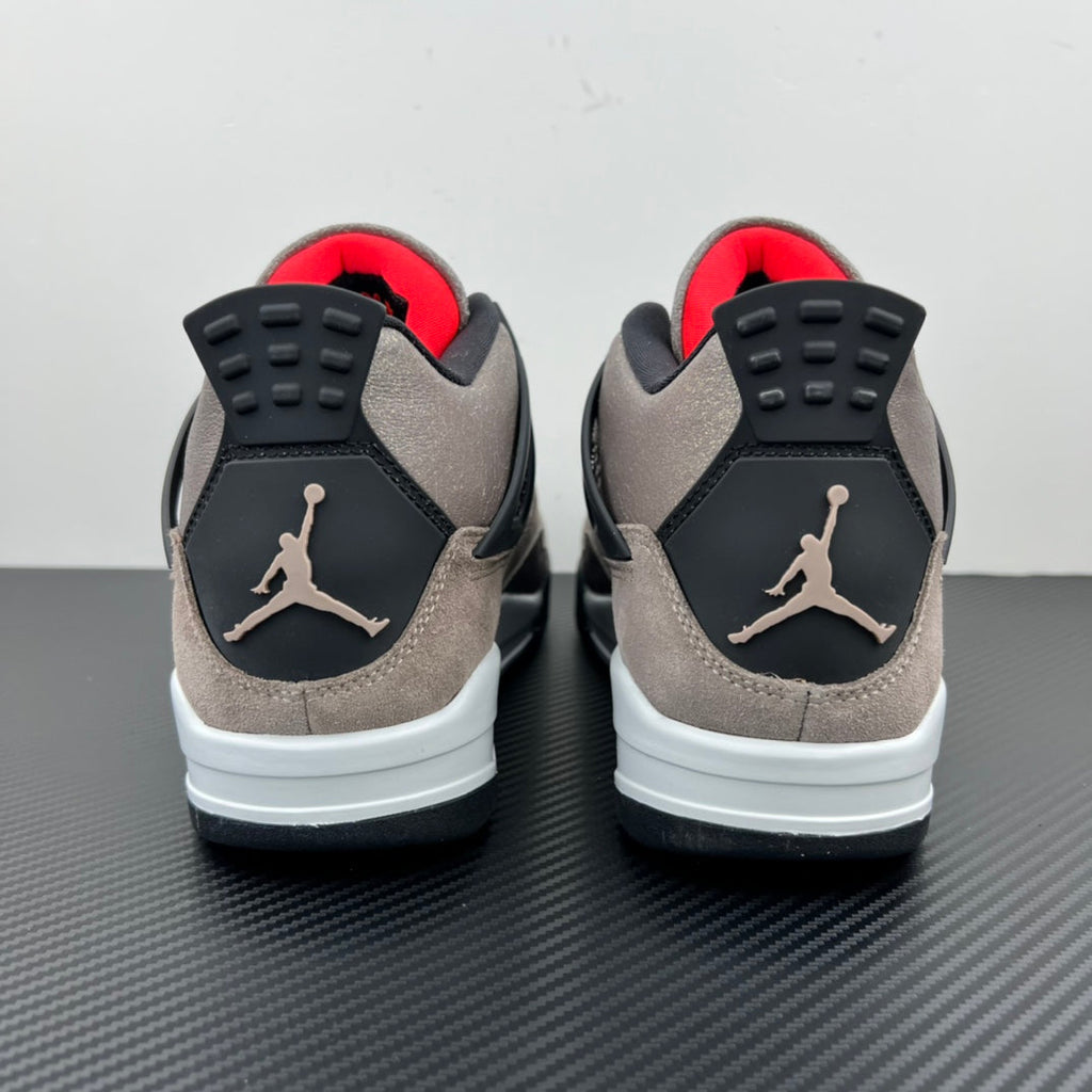 Back view of taupe Air Jordan 4 sneakers with black heel panels and white midsole
