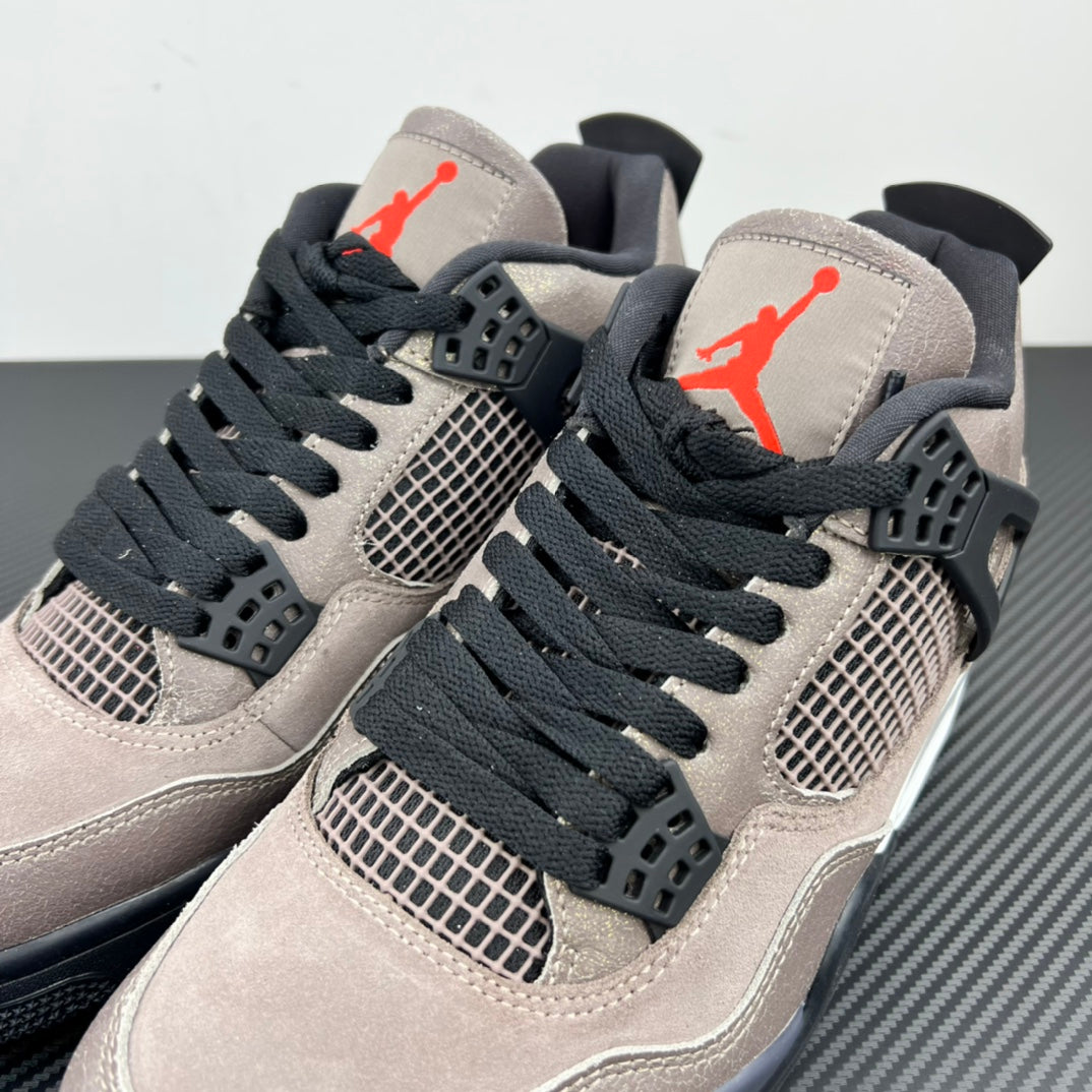Two Air Jordan 4 sneakers in taupe with black laces, mesh panels, and red logo hits