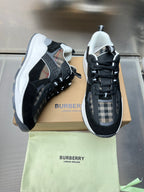 Black and gray lace-up sneakers with check panels and white midsoles