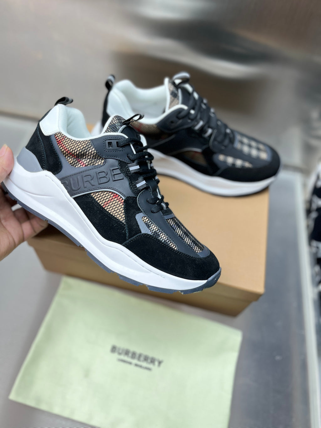 Black sneakers with white midsoles, lace-up, check-panel overlays