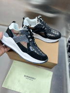 Black sneakers with white midsoles, lace-up, check-panel overlays