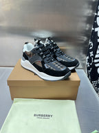 Black lace-up sneakers with metallic mesh panels and white rubber sole
