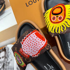 Louis Vuitton slide sandals with dark monogram strap and large red and white flower patch